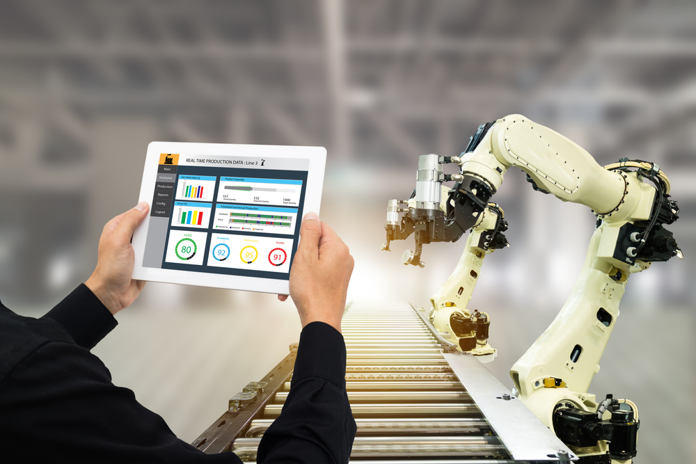 iot industry 4.0 concept,industrial engineer using software (augmented, virtual reality) in tablet to monitoring machine in real time.Smart factory use Automation robot arm in automotive manufacturing